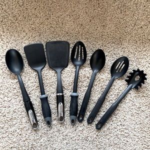 Assorted kitchen utensils: spatulas, spoon, slotted spoon, etc.
